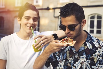 friends eating and drinking outdoors in the city