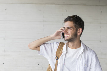 portrait of teenage student with mobile phone and book backpack