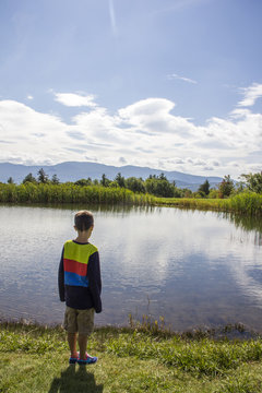 boy looking at a pond