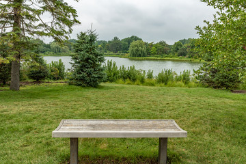 Fototapeta na wymiar Serene landscape with bench and pond