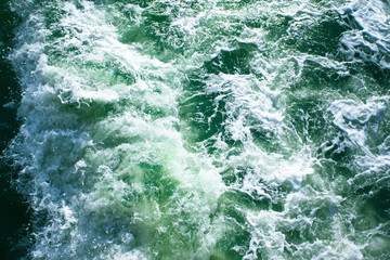Fototapeta premium surface of turquoise ocean water with white foam, background, texture