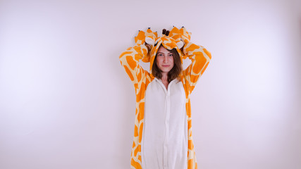 Funny girl in kigurumi pajamas. Emotional portrait of a student. costume presentation of children's...