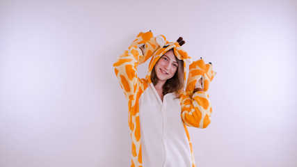Funny girl in kigurumi pajamas. Emotional portrait of a student. costume presentation of children's...