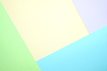 Fashionable  pastel colored paper flat lay top view, geometric background texture, pink, purple, yellow, beige, green and blue.