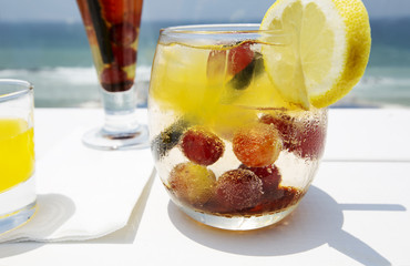  Cocktail drink on wood table on the sky background. Chill out and summer holiday concept