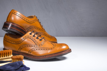 Pair of Luxury Male Tanned Full Broggued Oxford Calf Leather Shoes Along with Cleaning Accessories and Cloth.