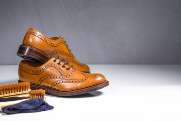 Pair of Luxury Male Tanned Full Broggued Oxford Calf Leather Shoes Along with Cleaning Accessories and Cloth.