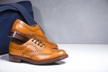 Pair of Luxury Male Tanned Full Broggued Oxford Calf Leather Shoes Along Messenger  Blue Bag on...