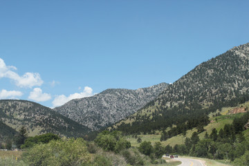 Mountains and valleys with dirt road and trees
