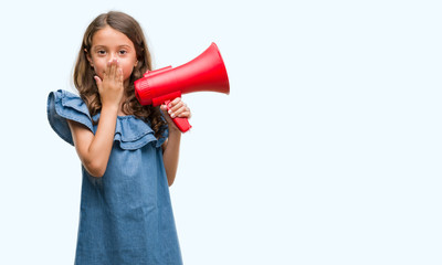 Brunette hispanic girl holding red megaphone cover mouth with hand shocked with shame for mistake, expression of fear, scared in silence, secret concept