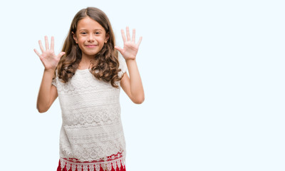 Obraz premium Brunette hispanic girl showing and pointing up with fingers number ten while smiling confident and happy.