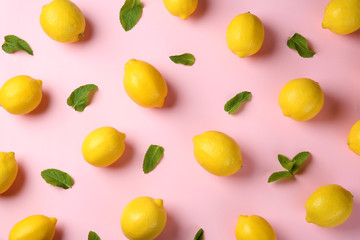 Flat lay composition with fresh ripe lemons and mint leaves on color background