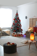 Stylish living room interior with decorated Christmas tree