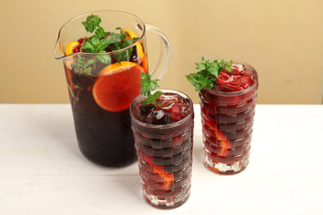 Glasses and jug with delicious refreshing cocktail on table