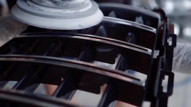 man grinds the grate before painting