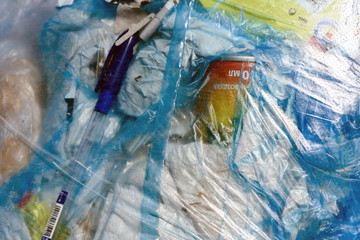 Closeup of blue plastic bin bags full of human domestic rubbish and trash