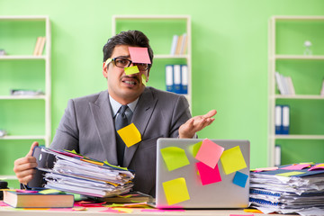 Businessman unhappy with many conflicting priorities sitting in 