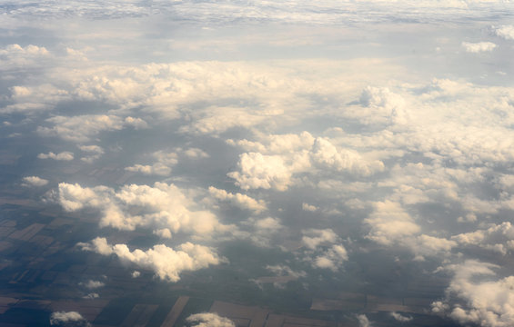 Huge cloudscape of clouds taken from an aerial position from the window of a plane high above the cloudline
