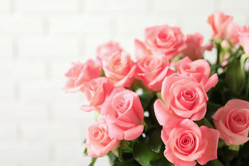 Bouquet of beautiful roses on blurred background