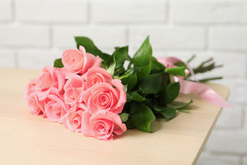 Bouquet of beautiful roses on table