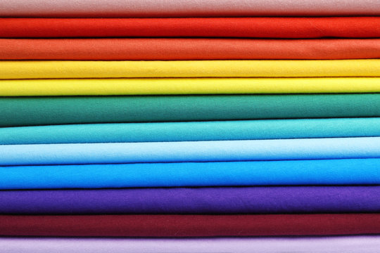 Pile of colorful t-shirts, close up view