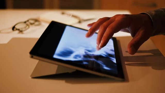 Doctor analyzing skull brain x-ray tommography medical data on touchscreen computer, work late at night scene, working with modern digital technologi in hospital concept