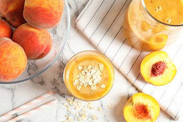 Peach smoothie in glassware on table, top view