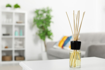 Aromatic reed air freshener on table in room