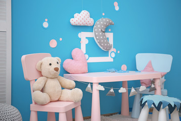 Modern interior of child game room with table, chairs and toys