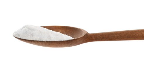 Spoon with baking soda on white background