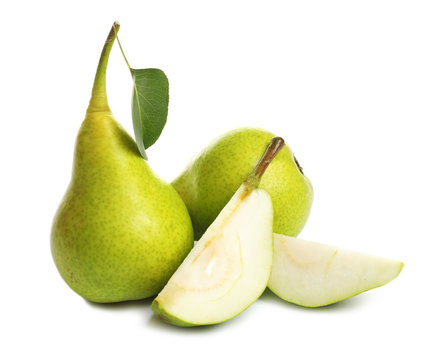 Whole and sliced pears on white background