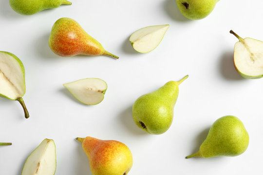 Fresh pears on light background, flat lay composition