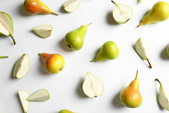 Fresh pears on light background, flat lay composition