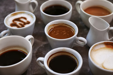 Obraz na płótnie Canvas Cups of fresh aromatic coffee on grey background