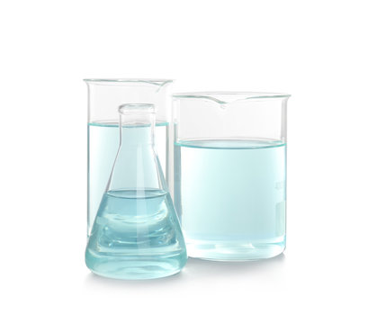 Laboratory glassware with liquid on white background. Chemical analysis