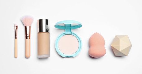 Set of makeup products on white background, top view