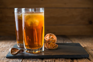 Bael juice ice tea on wooden table , healthy drink