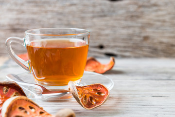 Bael tea juice on wooden table , healthy drink
