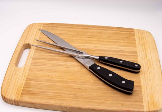 cutting board with carving knife and fork