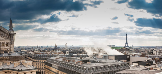 Sun rays over the beautiful Paris City seen from the rooftop of the Lafayette Galeries in a cold winter day