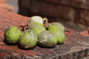 Close up green olive fruits on wood table