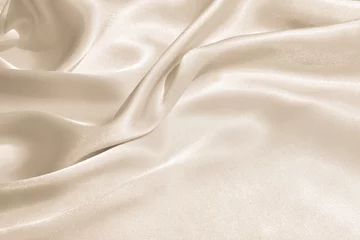 Foto op Plexiglas Stof De textuur van de satijnen stof van beige kleur voor de achtergrond