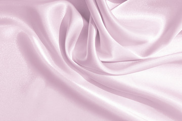 The texture of the satin fabric of pink color for the background