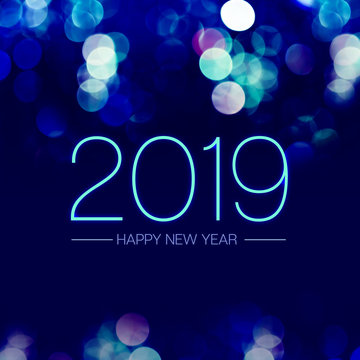Happy new year 2019 with blue bokeh light sparkling on dark blue purple background,Holiday greeting card.
