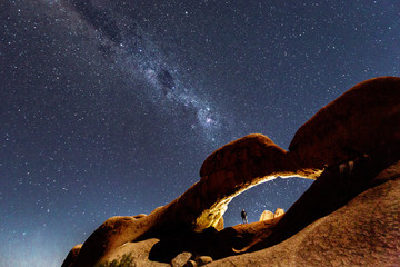 Milky Way shines over an arch in the desert