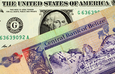 American one dollar bill with a colorful two Belize dollar bank note
