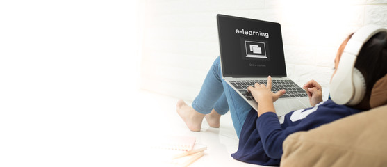 asian child asian child using laptop with inscription on screen e-learning . Online...