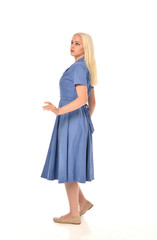 full length portrait of blonde girl wearing blue dress, standing pose. isolated on white  studio background.
