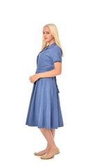 full length portrait of blonde girl wearing blue dress, standing pose. isolated on white  studio background.