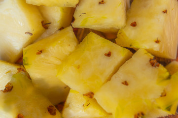 Ripe yellow pineapple slices kept on a plate ready to eat